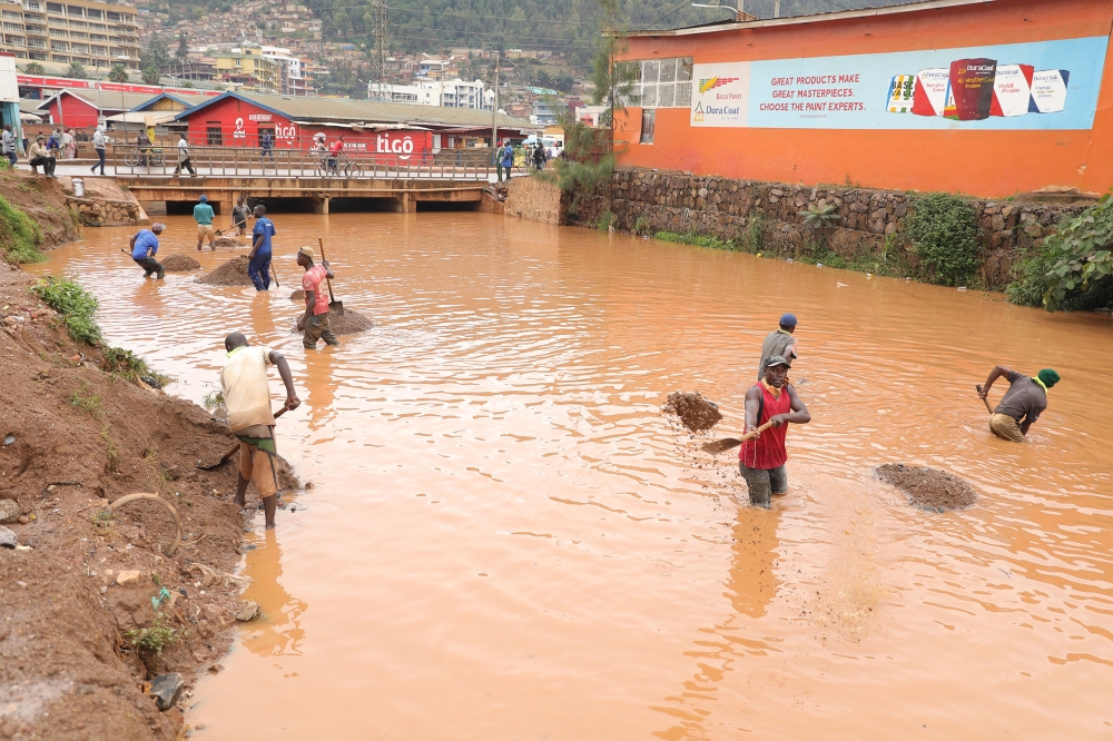 Workers removing sands in Mpazi drainage at Nyabugogo before upgrading the channel to avoid floods and water pollution in Nyabugogo river in Kigali. / Photo by Craish Bahizi