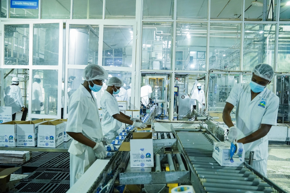 Workers package milk at Inyange Industries in Kigali on December 16, 2021. / Courtesy
