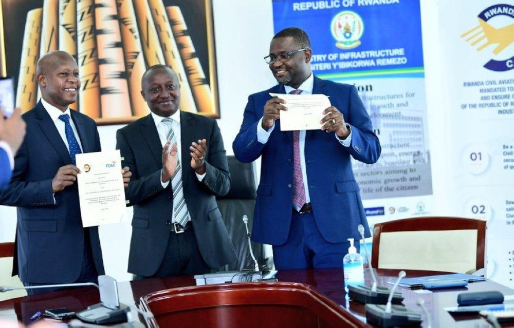 Silas Udahemuka, Director General of Rwanda Civil Aviation Authority (left), and his Tanzanian counterpart Hamza Johari (right), alongside Permanent Secretary at the Ministry of Infrastructure Fidèle Abimana (centre), during the signing ceremony in Kigali on August 16. Photo: Courtesy.
