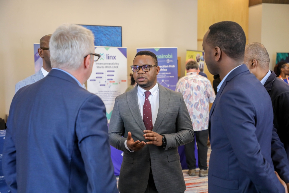 Yves Iradukunda, the Permanent Secretary in the Ministry of ICT and Innovation (centre), interacts with delegates at the African Peering and Interconnection Forum 2022 in Kigali on Wednesday, August 24. Photo: Dan Nsengiyumva.