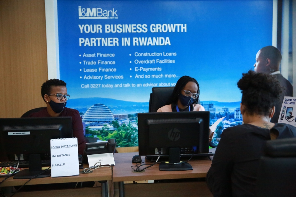 I &M Bank staff serve a customer at Kigali Heights branch. The Bank reported Rwf19.6 billion in net revenue, an increase of 20 per cent compared to June last year. Photo: Sam Ngendahimana.