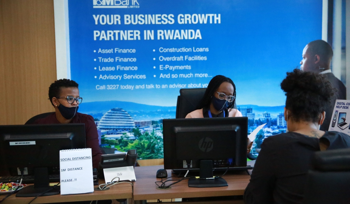 I &M Bank staff serve a customer at Kigali Heights branch. The Bank reported Rwf19.6 billion in net revenue, an increase of 20 per cent compared to June last year. Photo: Sam Ngendahimana.