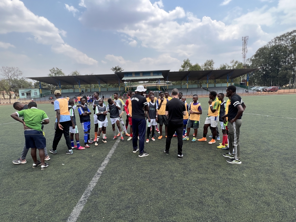 amie Fullarton (back to camera), alongside Jimmy Mulisa (wearing a white hat), hold trials for young Rwandan players last weekend at IPRC-Kigali. Fullarton is a former footballer with English Premier League sides Crystal Palace and Bolton Wanderers F.C. Photo: Courtesy.