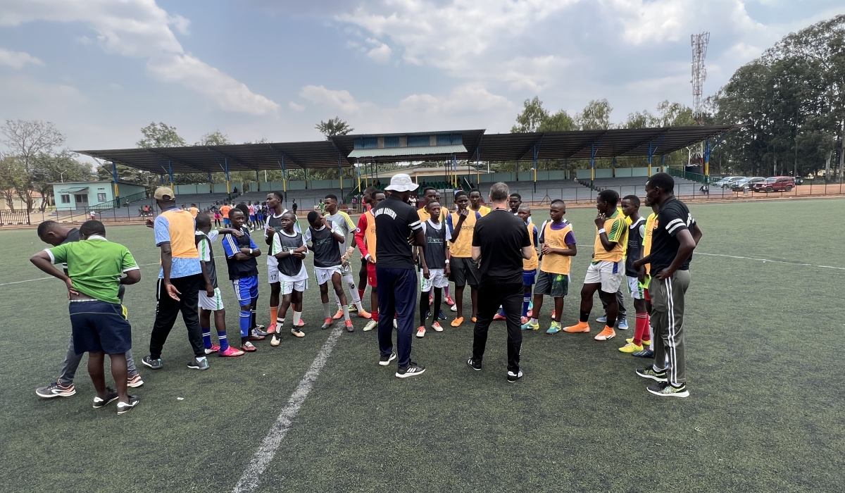 amie Fullarton (back to camera), alongside Jimmy Mulisa (wearing a white hat), hold trials for young Rwandan players last weekend at IPRC-Kigali. Fullarton is a former footballer with English Premier League sides Crystal Palace and Bolton Wanderers F.C. Photo: Courtesy.