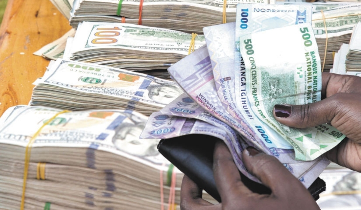A client counts money in a forex bureau in Kigali. Photo: Sam Ngendahimana