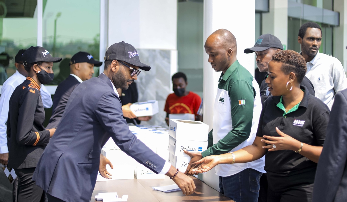 Radisson Blu staff serve breakfast packages to workers at M&M Plaza as a way to celebrate the six-year anniversary.