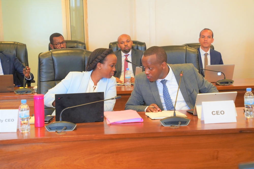 Deputy Chief Executive Officer of RSSB Louise Kanyonga with the  Chief Executive Officer of RSSB, Regis Rugemanshuro consult each other  as they appear before the Parliament’s Public Accounts Committee on  September 5th, 2022. Photo by Craish Bahizi