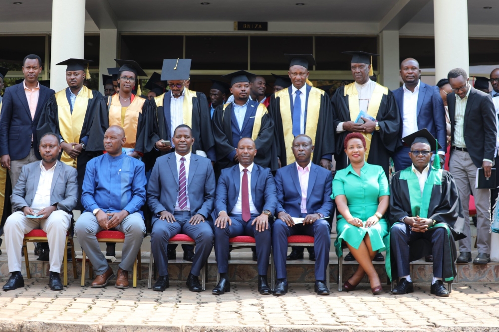 Officials pose for a group photo with some of the 246 customs professionals who  received the East Africa Customs and Freight Forwarding Practicing Certificate after completing a six month training . Courtesy