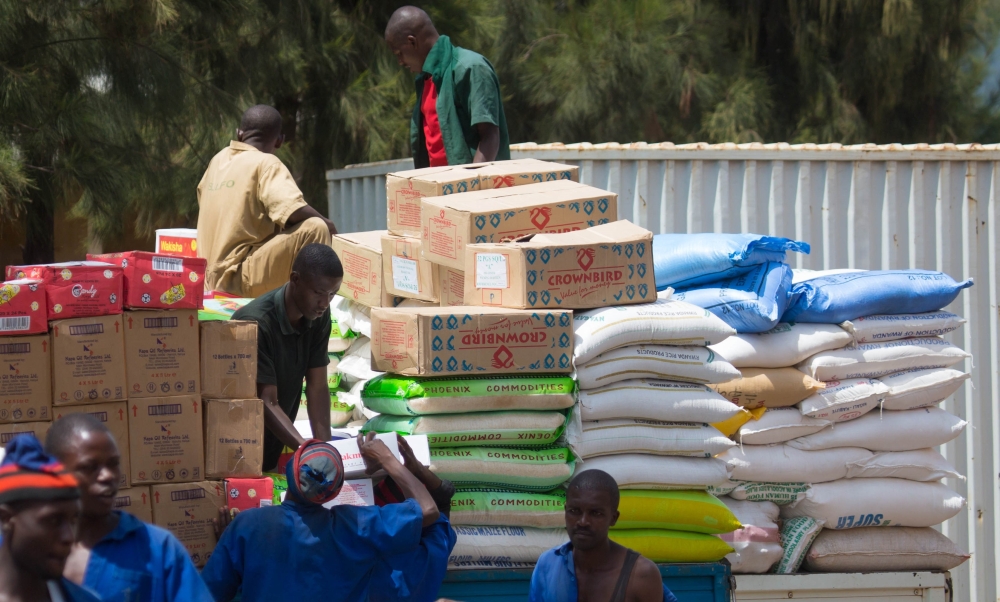 Workers load some of the imported food commodities for upcountry trading at Kigali Business District. / File