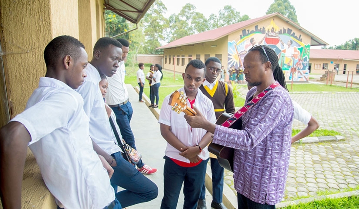 Jaques Muligande teaching some of the students at the school.  File photo.