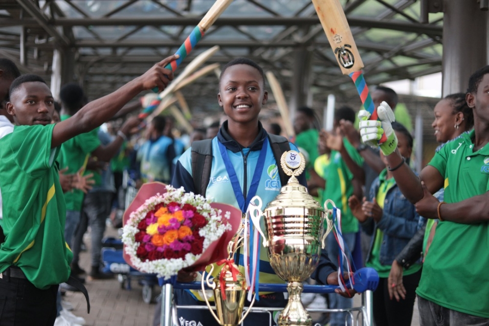 The skipper Gisele Ishimwe leads her teammates as the team arrives at Kigali International Airport on Wednesday. Gisele  was  also named the Player of the Tournament