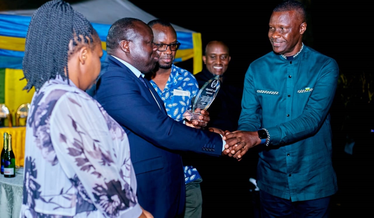 Maj Gen Charles Karamba, Rwanda’s High Commissioner to the United Republic of Tanzania and Seychelles (right), shakes hands with Christophe Bazivamo, during a farewell reception in honour of the Deputy Secretary General of the East African Community in charge of Productive and Social Sectors and his wife, in Arusha on September 17. / Photo: Courtesy