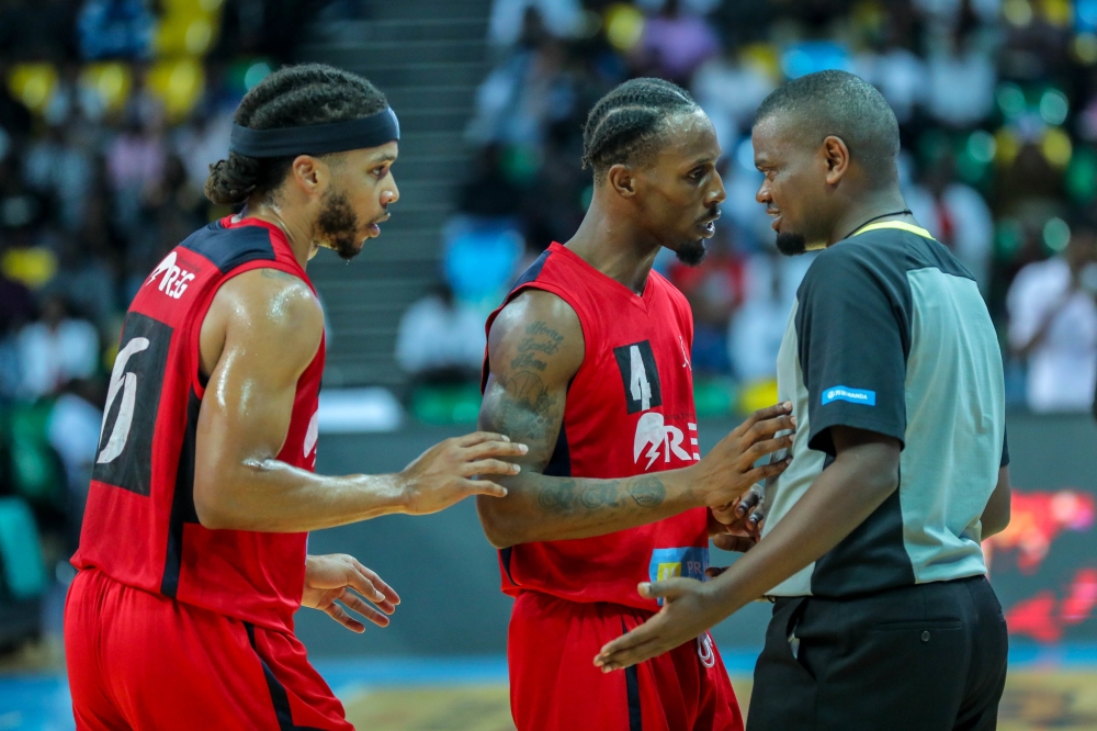 REG’s shooting guard Adonis and teammate Cleveland Thomas Jr confront the umpire during the final game of the play-offs on Sunday. The duo were instrumental as REG defeated Patriots 84-74. Photo: Dan Nsengiyumva.