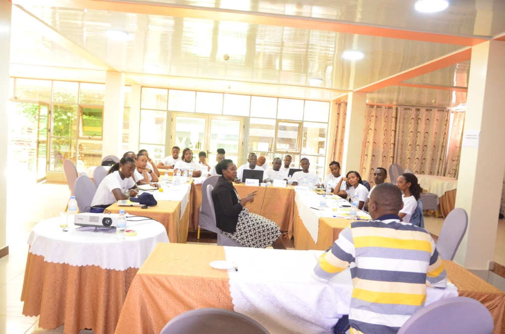 Sign language interpreter translating for Frida Umutoniwase while pursuing training on leadership skills. 