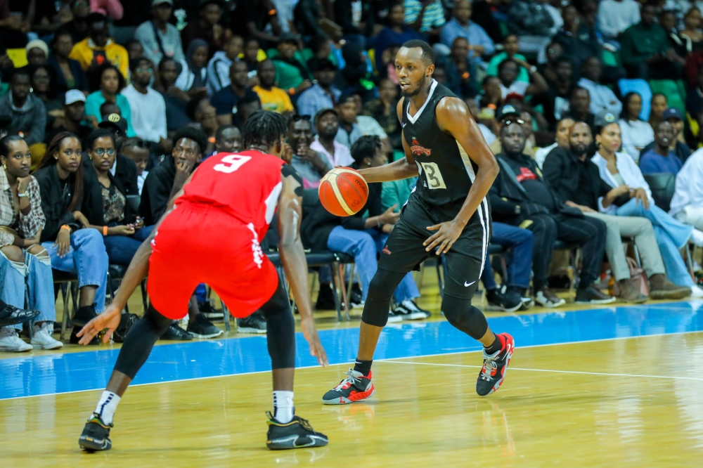 Patriots forward Steven Hagumintwari  tries to drible past REG’s US-based power-forward Axel Mpoyo during a past league game. Photo: Dan Nsengiyumva.