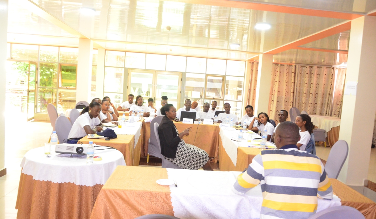 Sign language interpreter translating for Frida Umutoniwase while pursuing training on leadership skills. 