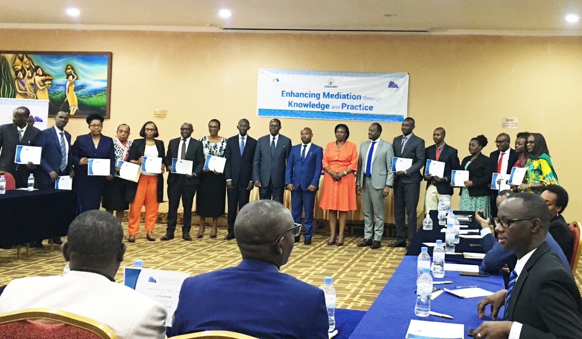 Officials pose for a photo with some of the 96 mediators certified 96 by the Supreme Court after completing a 6-month course in professional mediation in Kigali on July 6. Photo: Courtesy.