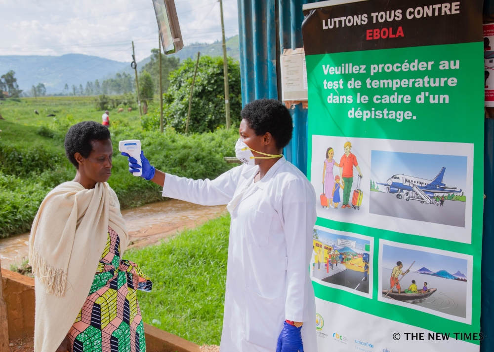A health worker during temperature screening at Gatuna border on May 27, 2019. All travellers entering Rwanda from Uganda are now subject to screening following an outbreak of Ebola in Uganda. / File