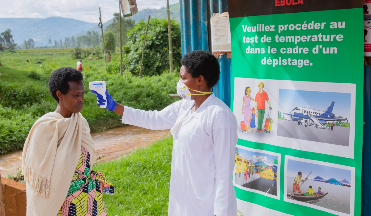 A health worker during temperature screening at Gatuna border on May 27, 2019. All travellers entering Rwanda from Uganda are now subject to screening following an outbreak of Ebola in Uganda. / File
