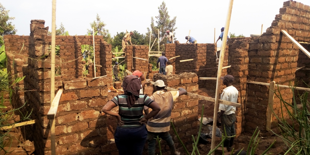 Workers construct a house using adobe (mud) bricks known as rukarakara in Kigali. Photo: Craish Bahizi.