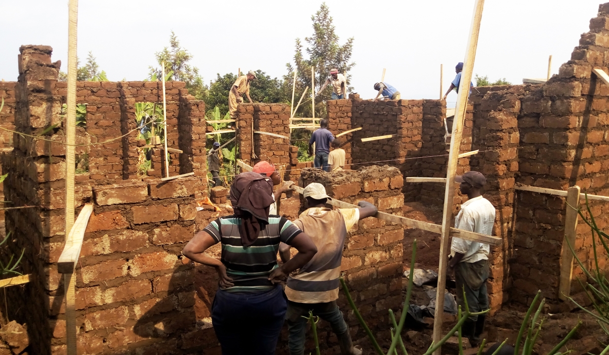 Workers construct a house using adobe (mud) bricks known as rukarakara in Kigali. Photo: Craish Bahizi.