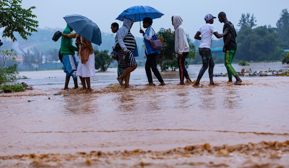 Pedestrians wade through a flooded street in Kigali. The new report shows that Rwanda is vulnerable to the consequences of climate change. / Photo: File