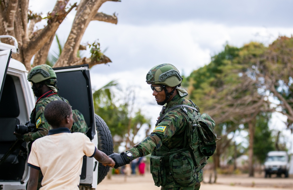 A  Rwandan soldier cheering with a child in Quionga Village. The Rwandan forces have established a good rapport with the local population in Palma and Mocimboa da Praia after purging terrorists in the two Cabo Delgado districts