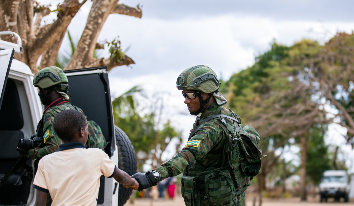 A  Rwandan soldier cheering with a child in Quionga Village. The Rwandan forces have established a good rapport with the local population in Palma and Mocimboa da Praia after purging terrorists in the two Cabo Delgado districts