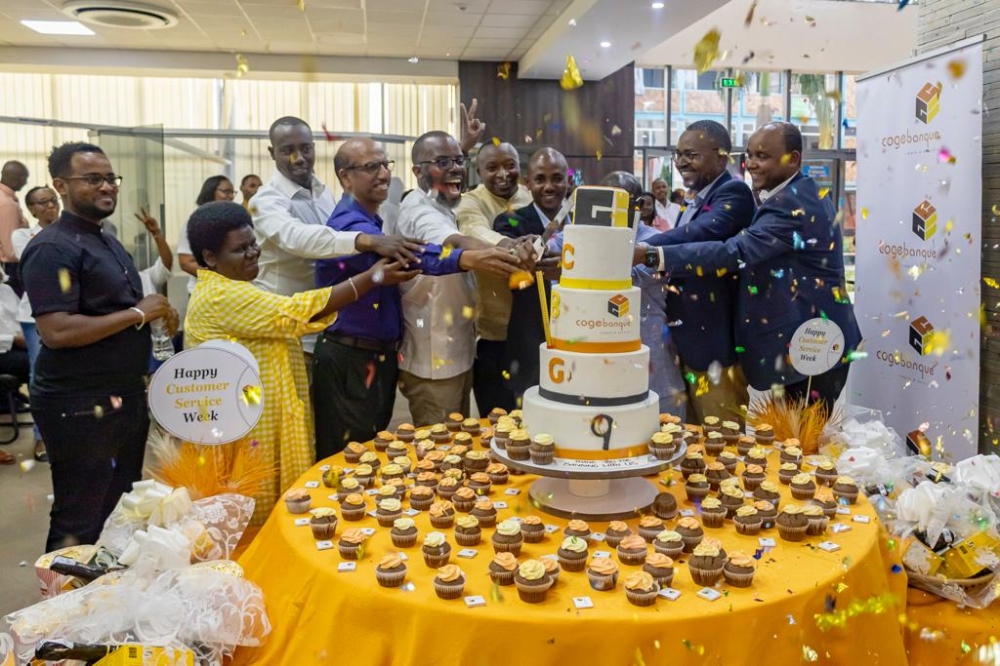Cogebanque  officials and  the bank’s customers and staff cut a cake as the bank concluded Customer Service Week on October 7. All photos by Dan Gatsinzi