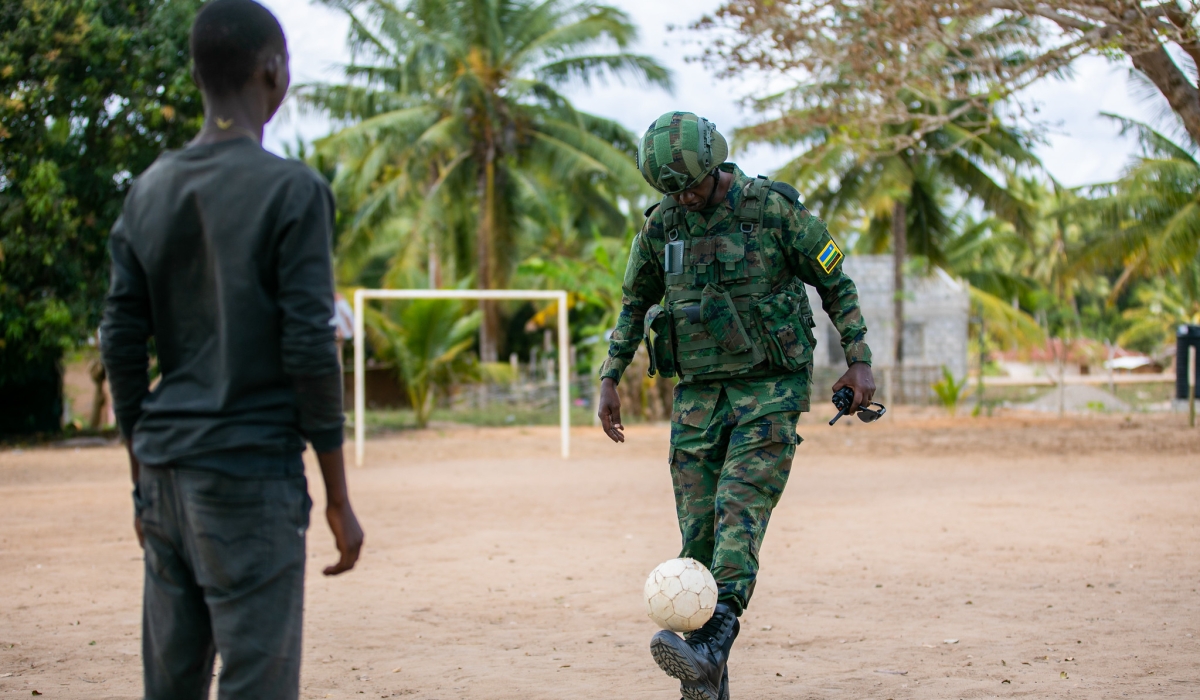 A Rwandan soldier playing football with a young boy at  Escola Primaria Completa de Mute. All pictures by Oliver Mugwiza
