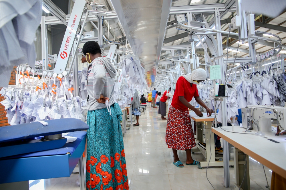 Workers at Pink Mango garment factory at Kigali Economic Zone. IMF has highlighted a 25 per cent probability for the global economic growth to fall below 2 per cent in 2023. File