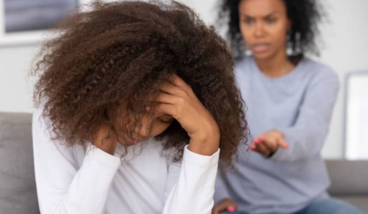 Upset african american teenage girl feeling sad turned back to angry strict black mother scolding lecturing difficult kid for bad behavior, mad mom arguing shouting at stubborn child teen daughter