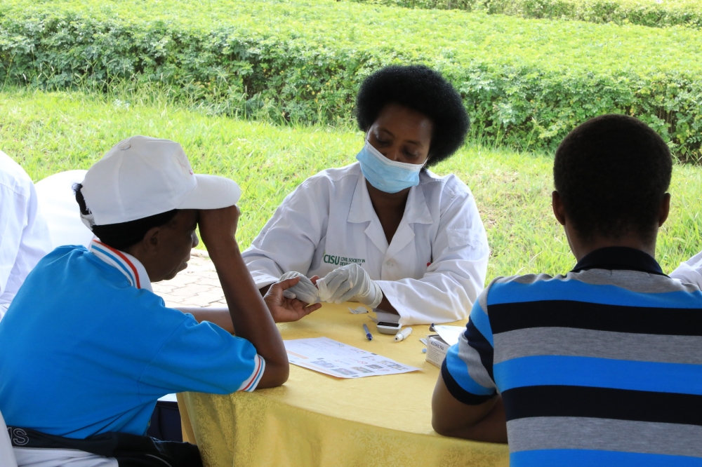 Medics  conduct a screening exercise for  women and girls for breast cancer using breast clinical examination. Craish Bahizi