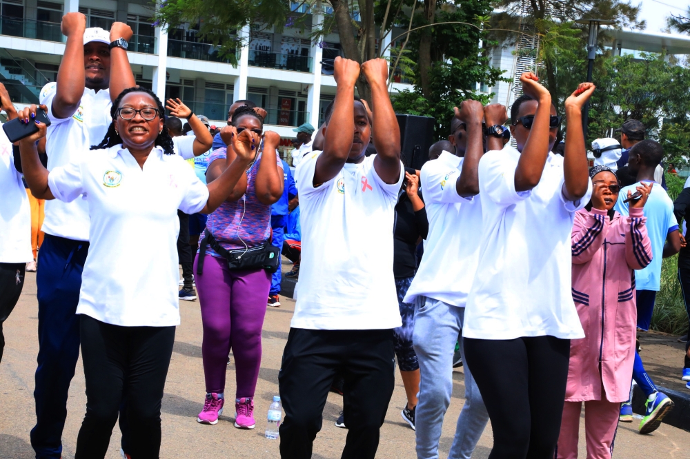Participants stretching during the mass sports exercise that raised awareness on Breast Cancer on Sunday .  The Sunday's event coincided with this year's Breast Cancer Awareness Walk, as part of the activities to mark the Breast Cancer Awareness month. Craish Bahizi