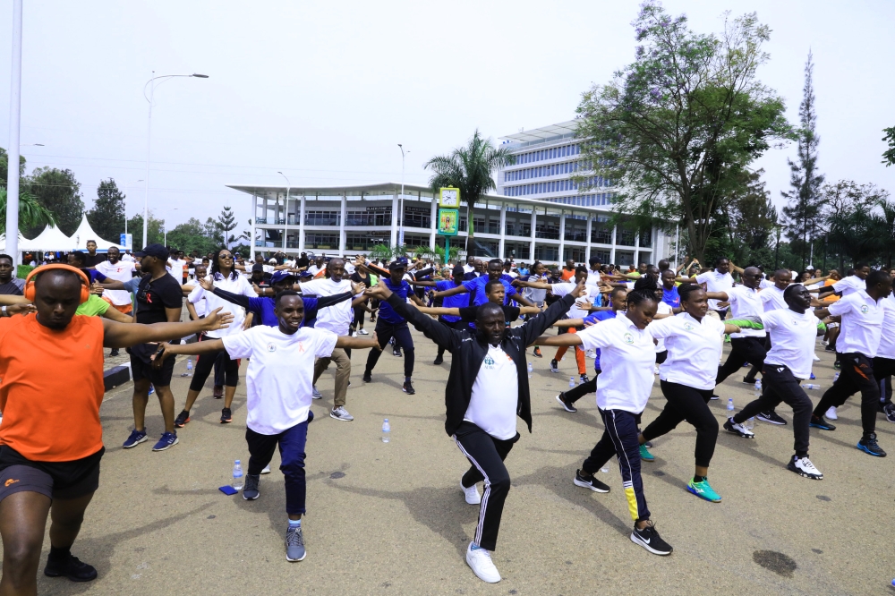 Participants stretching during the mass sports exercise that raised awareness on Breast Cancer on Sunday . Craish Bahizi