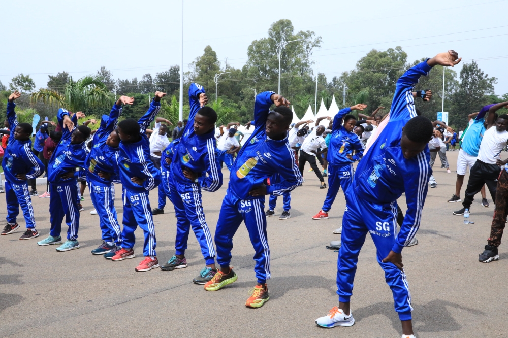 Kigalians   stretching their bodies matching their moves with the beat of the music during the Kigali Car Free Day that raised awareness on Breast Cancer, on October 16. Photo by Craish Bahizi