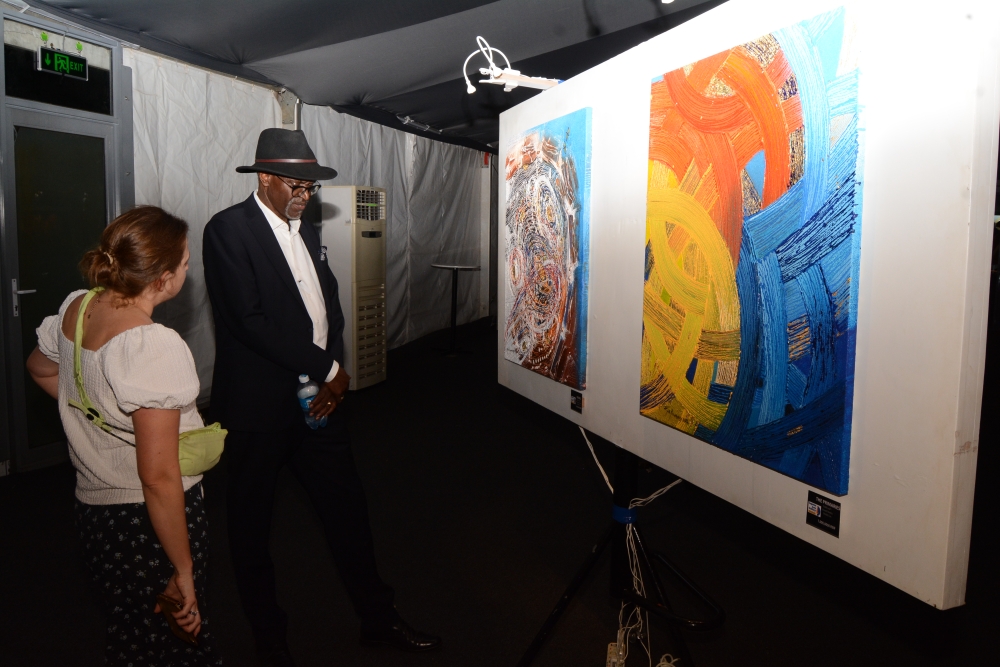 Epa Binamungu explaining his art pieces to a guest.  / Courtesy photos