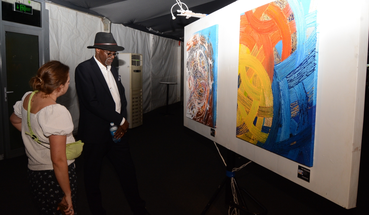 Epa Binamungu explaining his art pieces to a guest.  / Courtesy photos