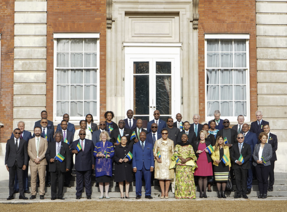 Officials pose for a group photo as Gabon’s flag raised to mark entry into the Commonwealth
