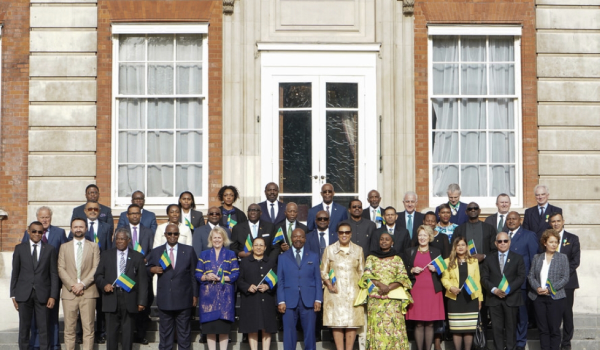 Officials pose for a group photo as Gabon’s flag raised to mark entry into the Commonwealth