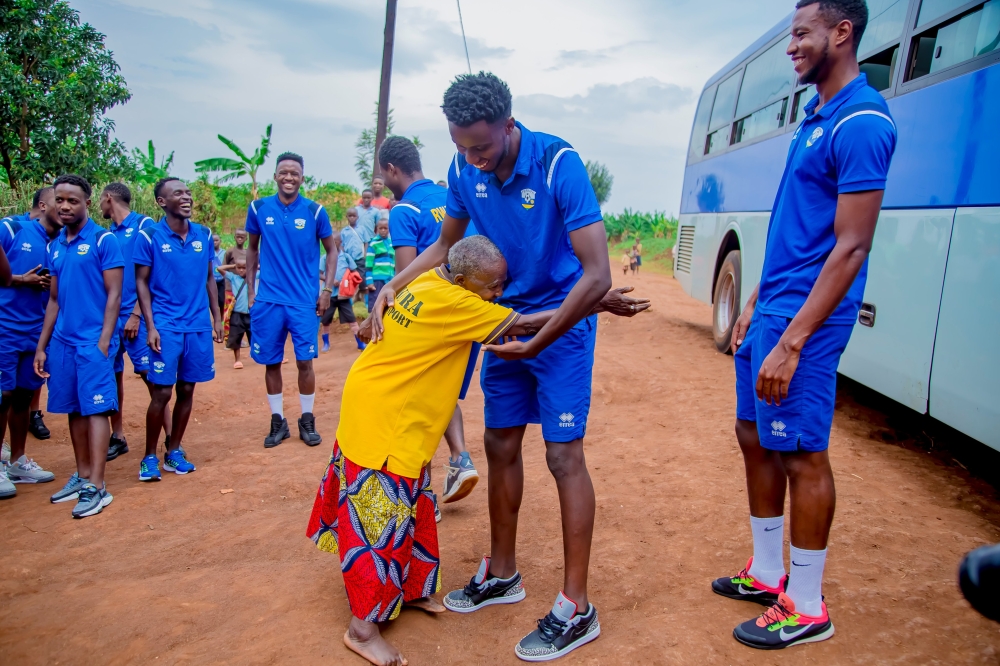 National team players  meet Madeleine Mukanemeye, a 96-year-old  national football team fan at her home in  Munazi Cell,Save Sector in Gisagara District ,on October 18. The U-23 National Football Team visited her  to recognize her tireless efforts to support national team.