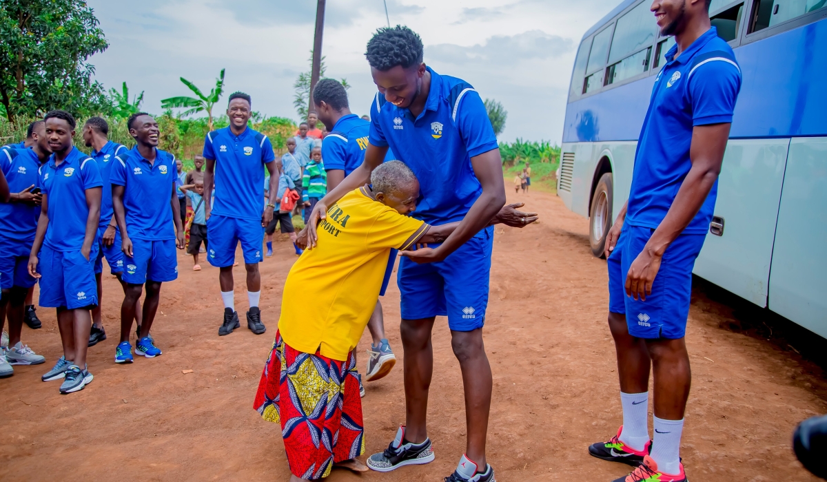 National team players  meet Madeleine Mukanemeye, a 96-year-old  national football team fan at her home in  Munazi Cell,Save Sector in Gisagara District ,on October 18. The U-23 National Football Team visited her  to recognize her tireless efforts to support national team.