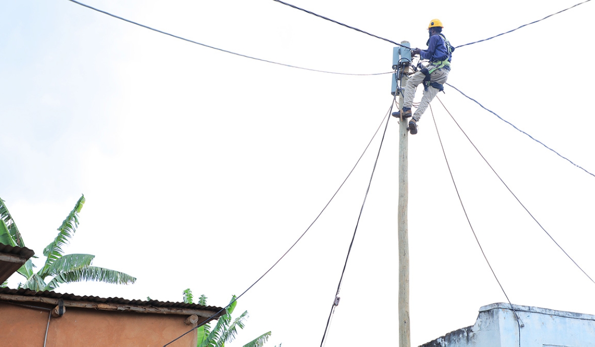 A technician checks an electricity Pole in Gicumbi District. Minister Erneste Nsanzimana, has disclosed that the Government will use Rwf500 billion to support its universal electrification efforts. File