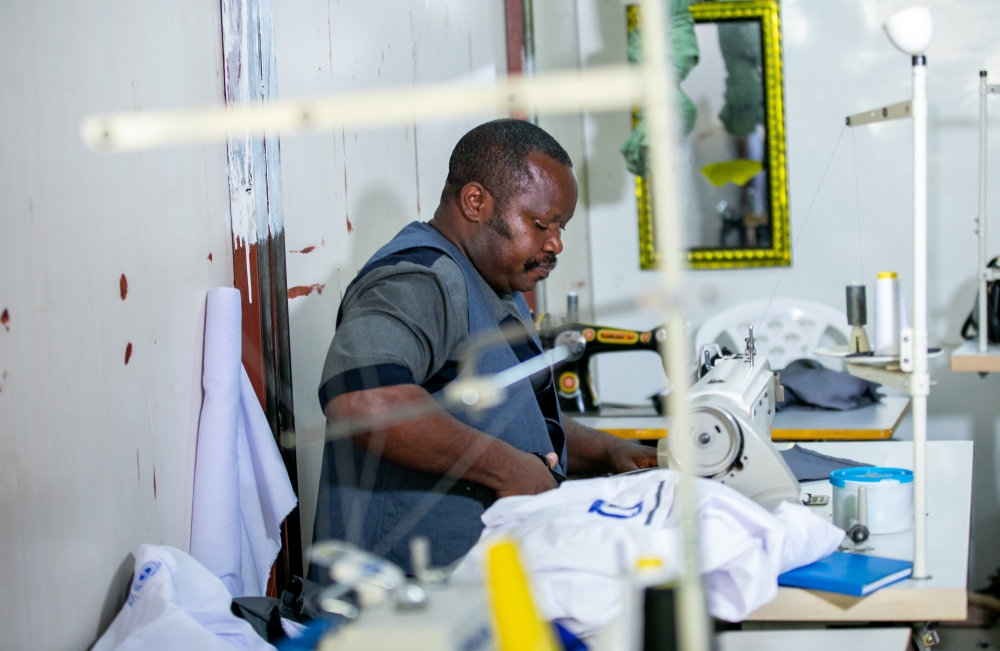 Murera takes part in a tailoring activities in his factory