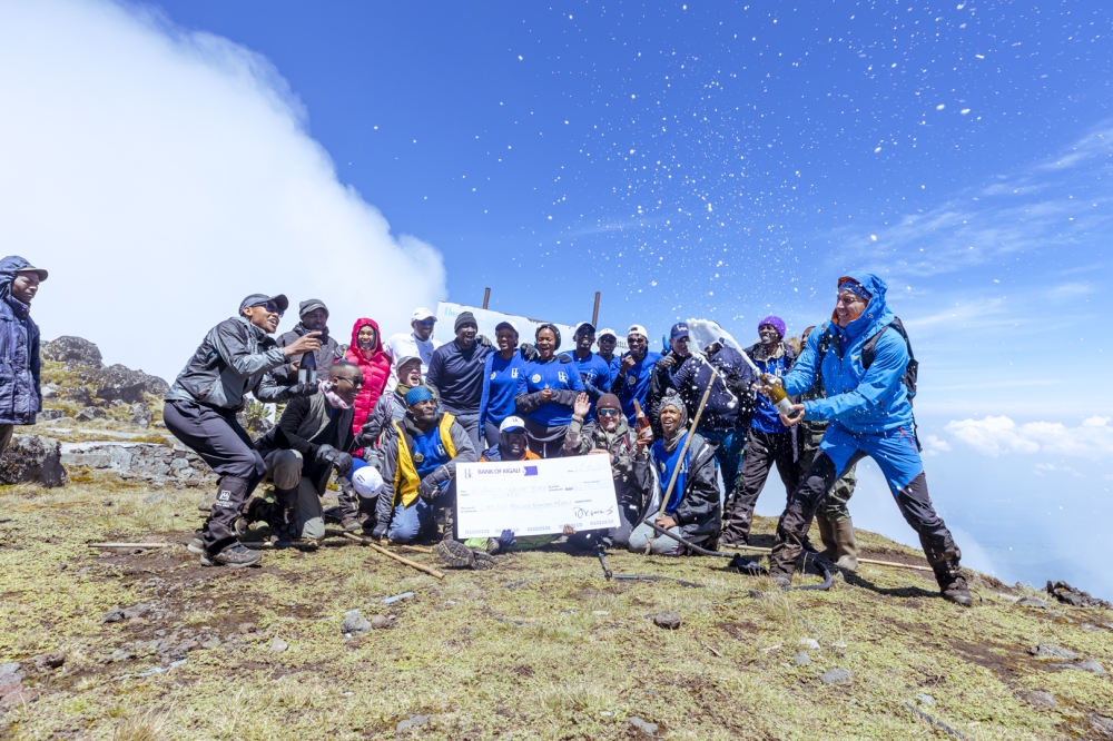 Employees of Bank of Kigali and Agahozo Shalom Youth Village celebrate after hiking Mount Karisimbi for  a Rwf62 million fundraising campaign last week. Courtesy
