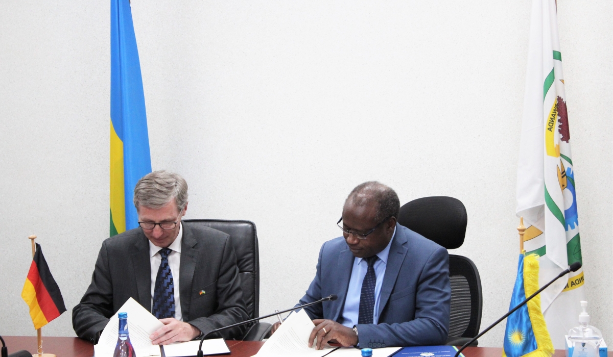Simon Koppers, Head of Division, German Federal Ministry for Economic Cooperation and Development (BMZ), and Uzziel Ndagijimana, the Minister of Finance and Economic Planning sign the agreement in Kigali on October 26. Courtesy
