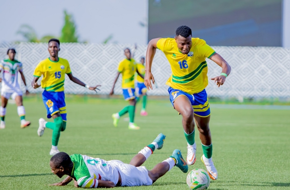 The U-23 National Football Team midfielder Arthur Gitego wins the ball against Malian defender during a 1-1 draw at Huye stadium. Photo: Courtesy.