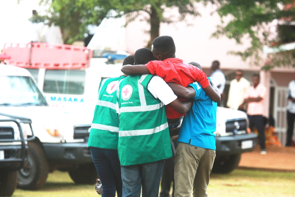 Volunteers help a trauma victim during a commemoration event at Nyanza Genocide Memorial on May 4, 2019. Some youths have shared their views on what can be done to address mental health issues. Sam Ngendahimana