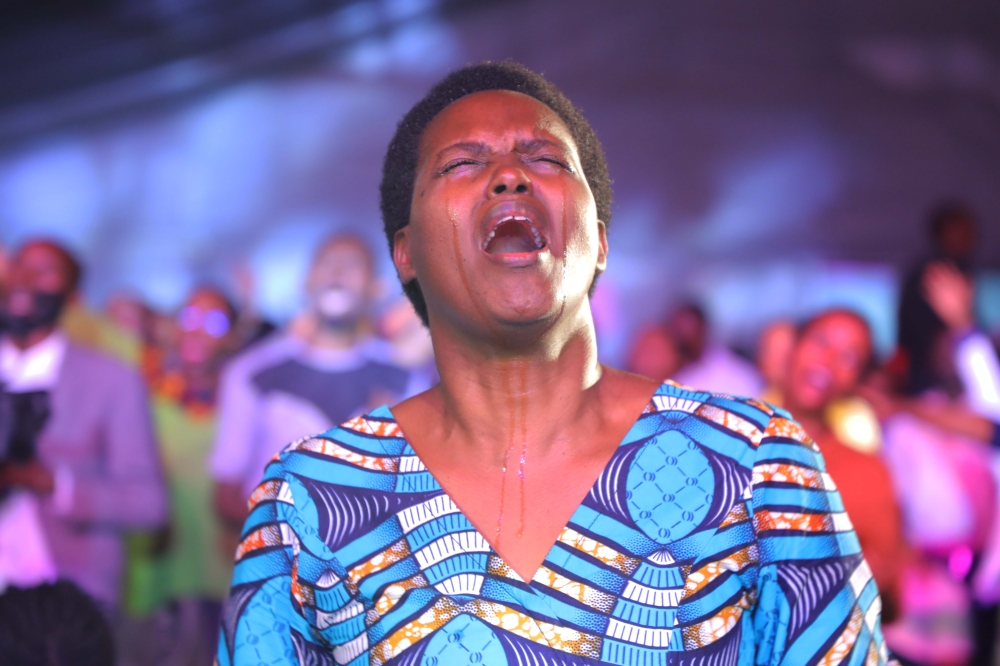 One of thousands Christians who turned up for the Unconditional Love Live Concert, seen here worshiping God as Alexis Dusabe introduced Tugumane Mwami ,Halleluya, Mwami Tugumane &#039;&#039; the song  that spiritually and emotionally brought a state of feeling the presence of God in the auditorium on Sunday, October 30.