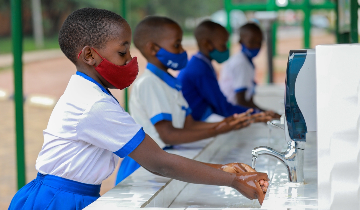 Children wash their hands to prevent the spread of Covid 19 at Groupe Scolaire Kicukiro on January 13, 2021. According to the Ministry of Health, over two million children under 12 will get Covid jab before end of the year.